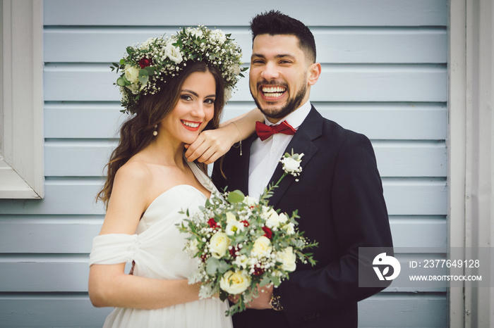 young couple bride groom getting married wedding posed photos at seaside sea beach hairpiece flowers bouquet church