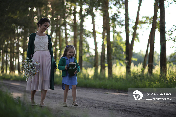 Mother with daughter walking on a road