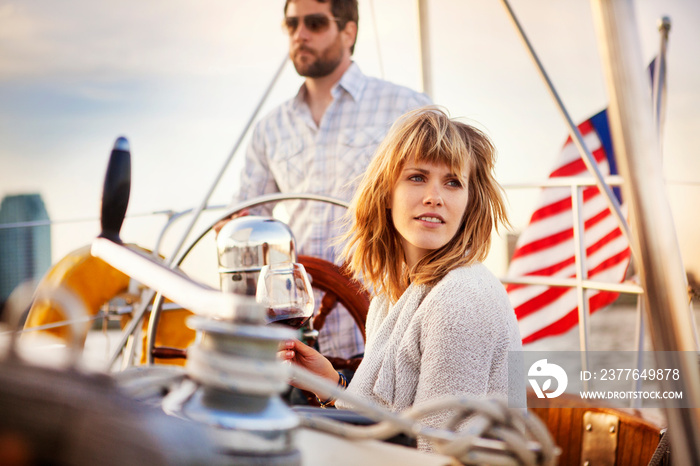 Couple sailing woman looking away