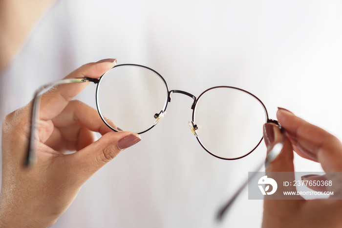 woman hand hand holding eyeglasses closeup ,healthcare and medical concept