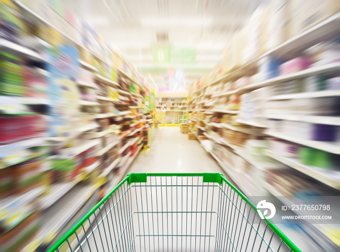 Supermarket store abstract blur background with shopping cart, Supermarket aisle with empty shopping cart