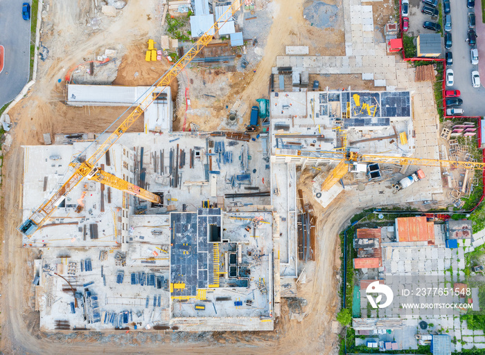 Aerial view of the beginning of the construction of the house, laying the foundation. Construction crane. View from above exactly.