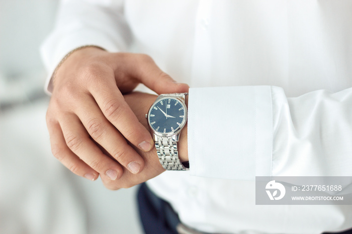 businessman clock clothes, businessman checking time on his wristwatch. men’s hand with a watch, watch on a man’s hand, putting the clock on the hand, fasten clock watch time, man’s style