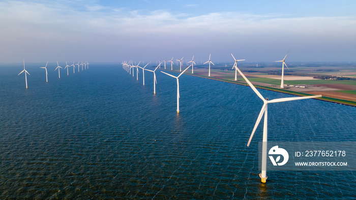 Windmill park with windmills turbines and a blue sky generating electricity green energy concept