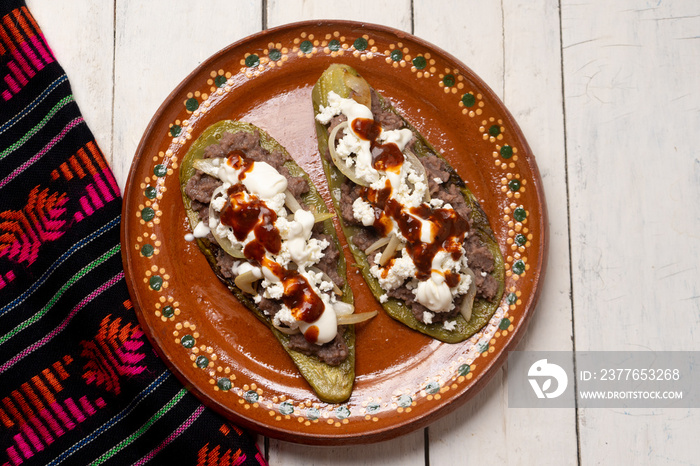 Mexican nopal cactus huaraches with cheese and beans on white background