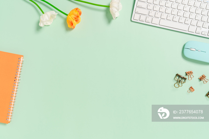 Minimal work space - Creative flat lay photo of workspace desk. Top view office desk with keyboard, mouse and notebook on pastel green color background. Top view with copy space, flat lay photography.