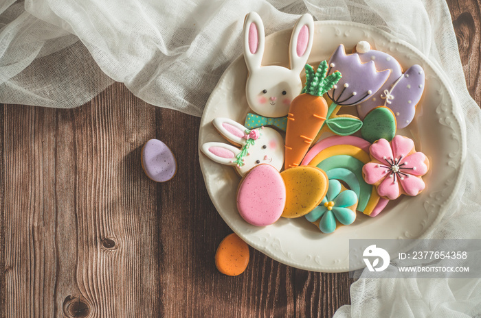Happy Easter. Multi-colored pastel easter cookies on a wooden background.