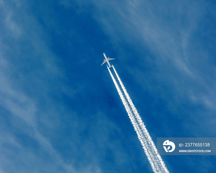 Huge passenger plane, Airbus or Boeing flying in high altitude over Old Town Square, Prague in Czech Republic, Central Europe.