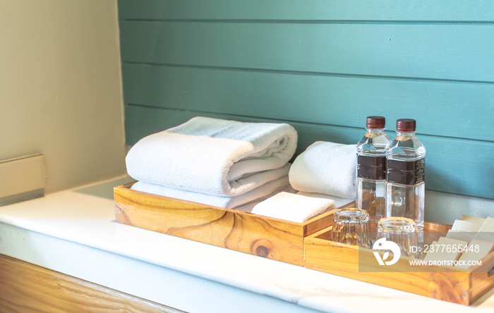 A set of hotel toiletries with white clean towel in a bathroom, copy space