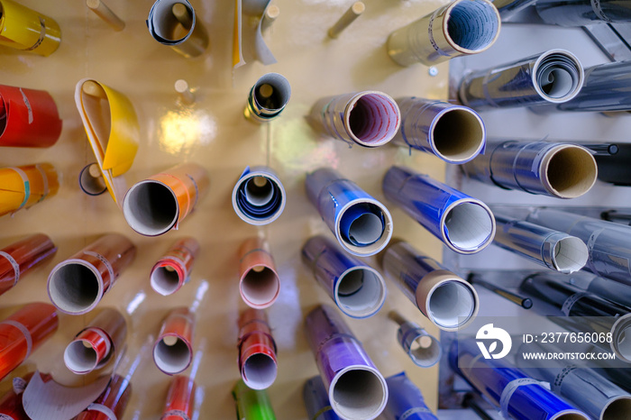 many colorful adhesive foils are on the wall of a design studio