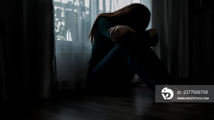 Sad young woman sitting on the bed in the bedroom, People with depression concept.