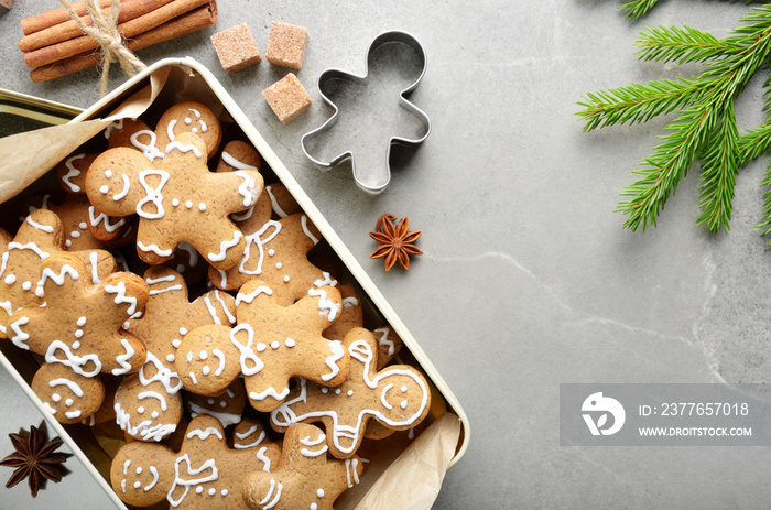 Flat lay Christmas background with cookie box fir palm and cutter on stone table