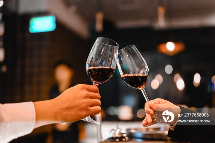 Two bartender enjoying of Cheers glass of wine for wine tasting event in a restaurant  at sunset. bartender, tasting, Dinner, Wine, beverage, dinner concept.