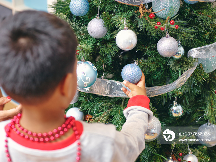 Boy decorating Christmas tree