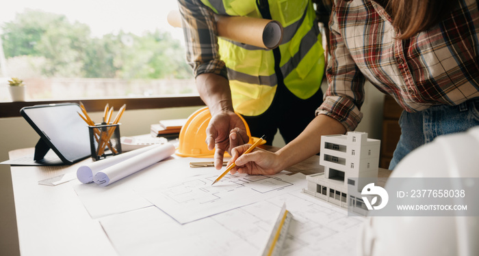 .Engineer people meeting working in modern office for discussing, engineering .Hands of Engineer working on blueprint Construction concept.