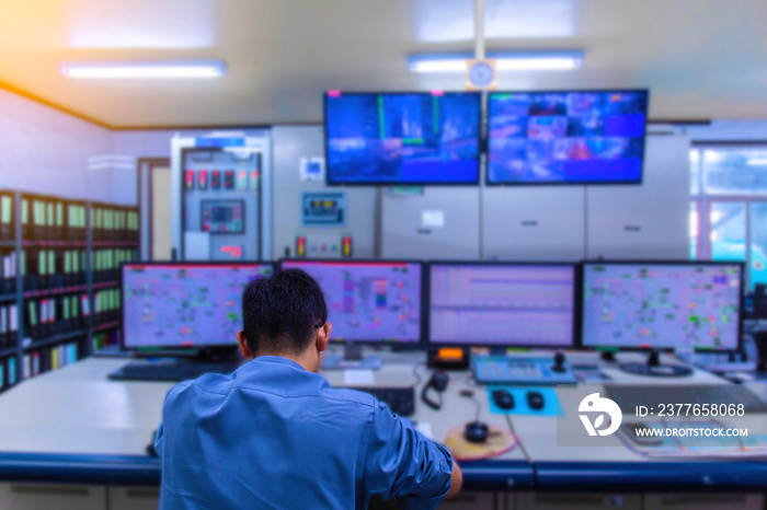 Double exposure Blurred light of man Engineering operations checking production process, Control room of a steam Turbine, Generators in the coal-fired power plant. Technology and industry concept