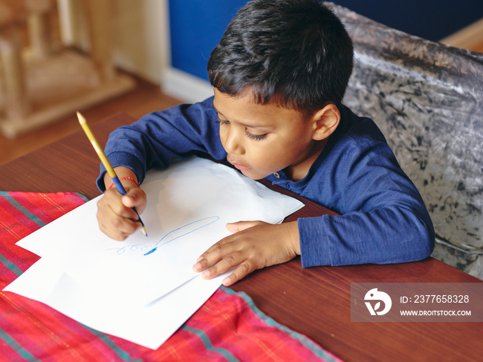 Boy drawing on paper