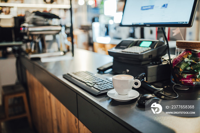 White coffee cup by the shop counter