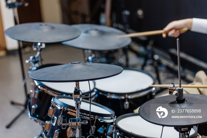 Someone playing a cymbol on a set of drumsat a local church for the praise and worship team or a band