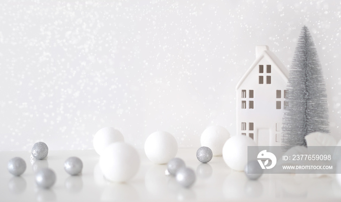 Christmas composition. Christmas balls white and silver, decorative house, christmas tree on a white background