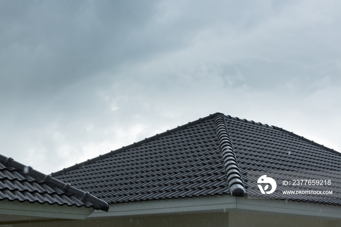 rain storm downpour on black roof tile of residential house