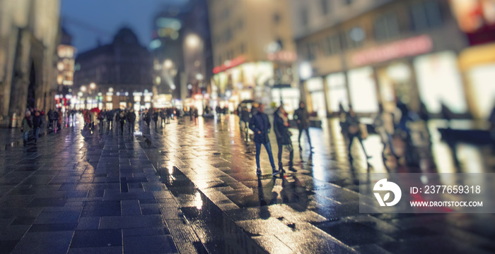 crow of people walking on rainy night streets