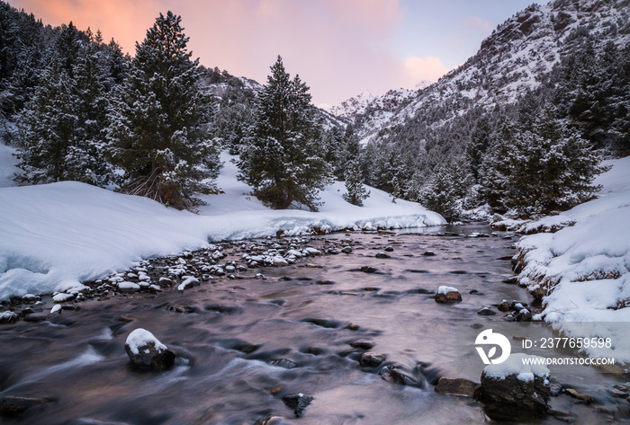 Sunrise on a snowy river of Ordino