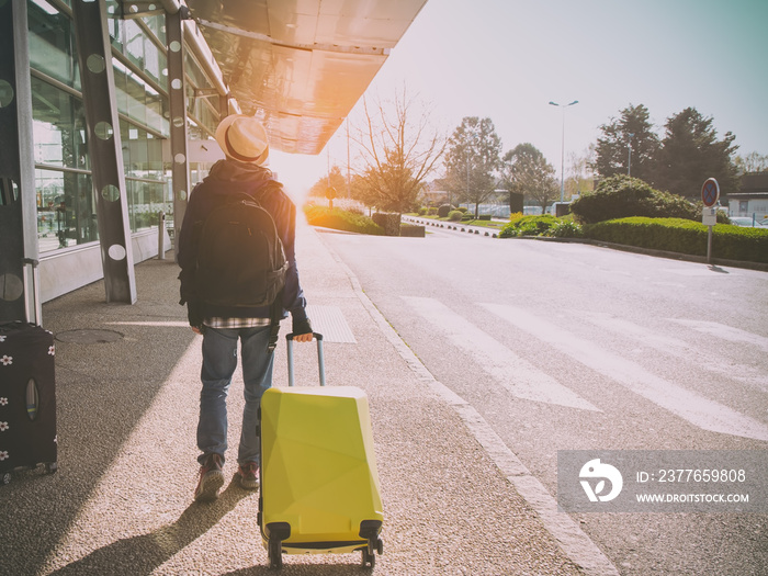 Tourist of young man and suitcase in the airport  which a travel concept,Holiday vacation concept, traveler suitcases in airport terminal