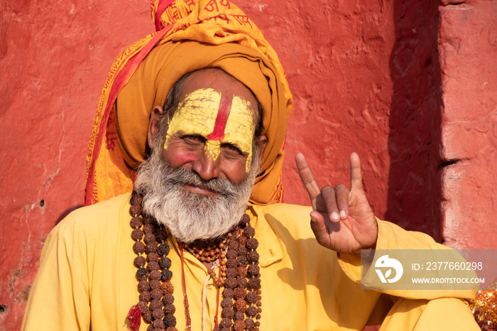 Kathmandu Sadhu men holy person in hinduism with traditional painted face at Pashupatinath Temple of Kathmandu - Non English word in image is prayer words