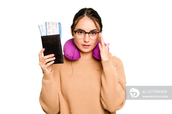 Young caucasian woman with inflatable travel pillow holding passport isolated on green chroma background pointing temple with finger, thinking, focused on a task.