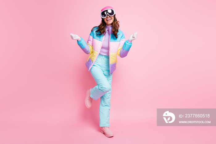 Full length photo of cute lucky woman skier dressed colorful windbreaker eyeglasses rising fists isolated pink color background