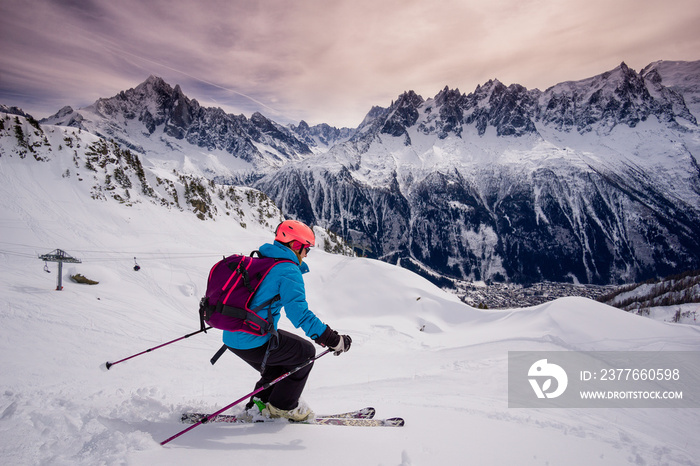 A woman freeride skiing in Chamonix, France under the Mont Blanc