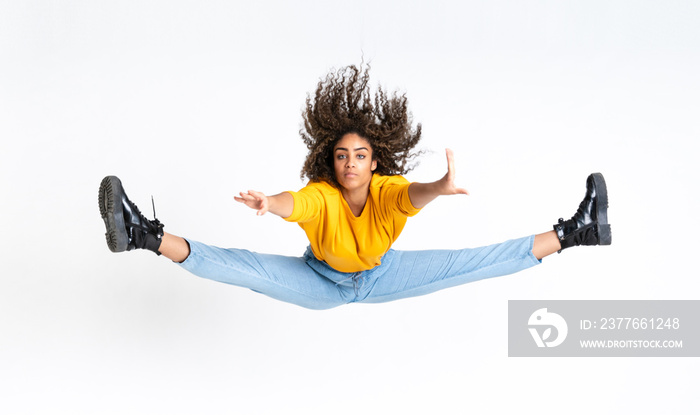 Young African American woman dancing over isolated white background