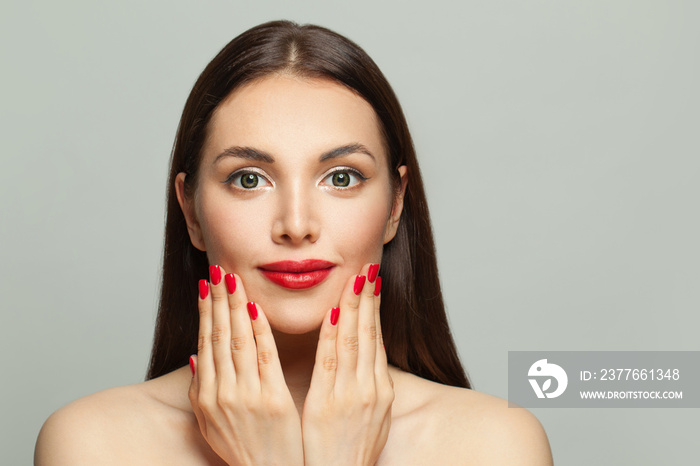 Beautiful woman face and manicured nails on hands on white background