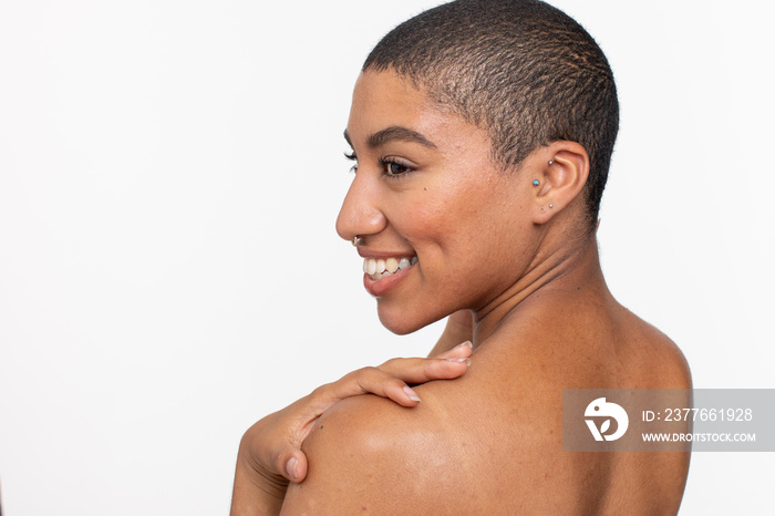 Studio portrait of shirtless smiling woman