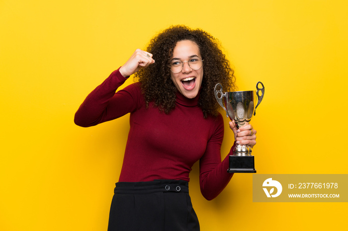 Dominican woman with turtleneck sweater holding a trophy