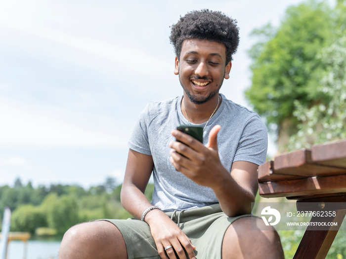 Smiling man during video call on sunny day