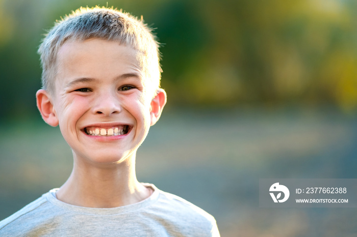 Portrait of a child boy outdoors on a warm sunny summer day.