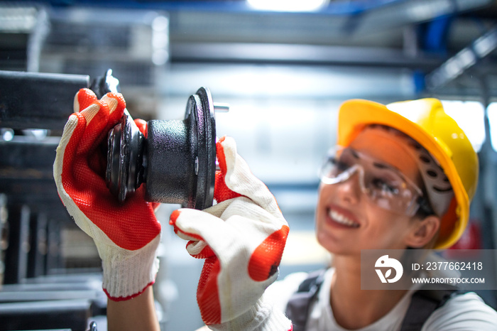 Factory worker working in production line assembling parts for automotive industry.