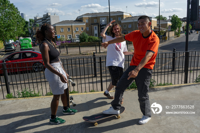 Young people skateboarding in skate park