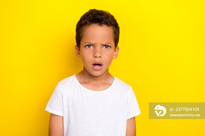 Photo of astonished boy dressed trendy clothes misunderstood what happened situation problem trouble isolated on yellow color background