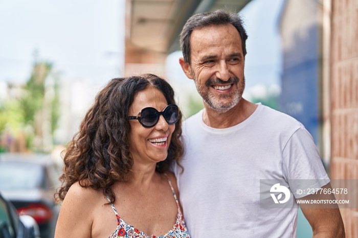 Man and woman couple smiling confident standing together at street