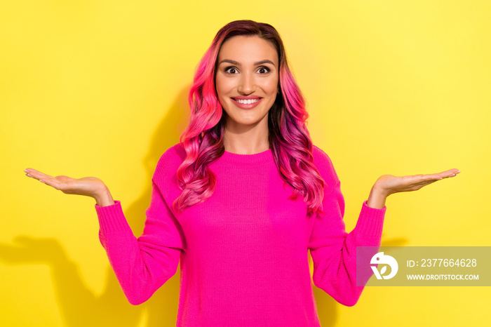 Photo of cheerful charming person arms palms demonstrate empty space vs scales isolated on yellow color background