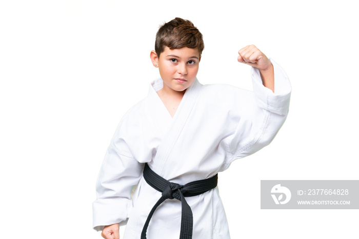 Little caucasian kid over isolated chroma key background doing karate