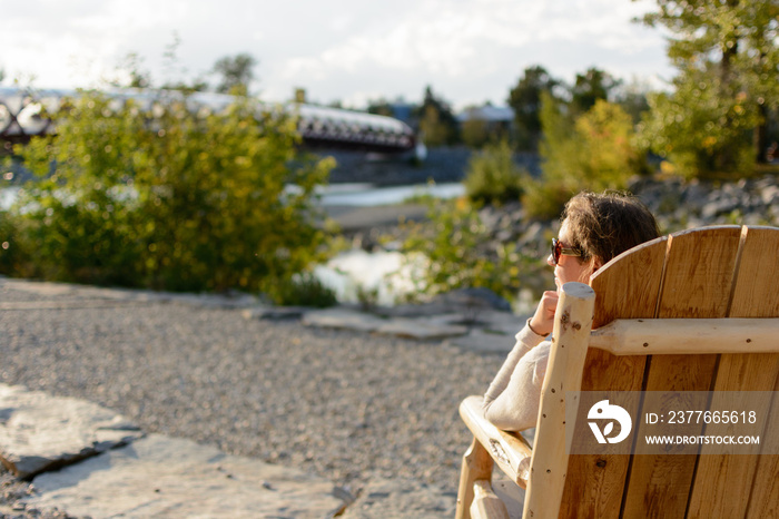 Woman sitting on a lounge chair enjoying the view