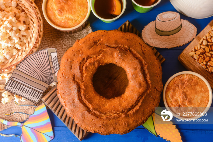 Traditional food for Festa Junina (June Festival) with symbols on color wooden background