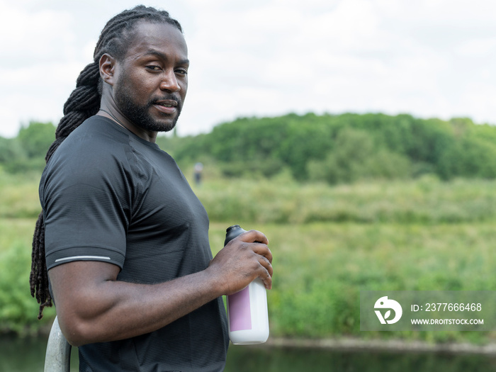 Man drinking from water bottle during workout