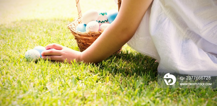 Little girl collecting easter eggs