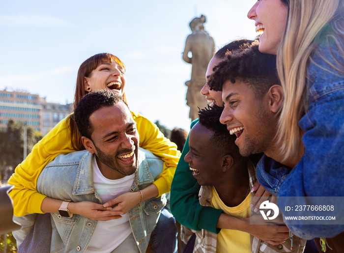 Young group of teenage student friends having fun together outdoors. Millennial diverse people enjoying travel vacation in city.