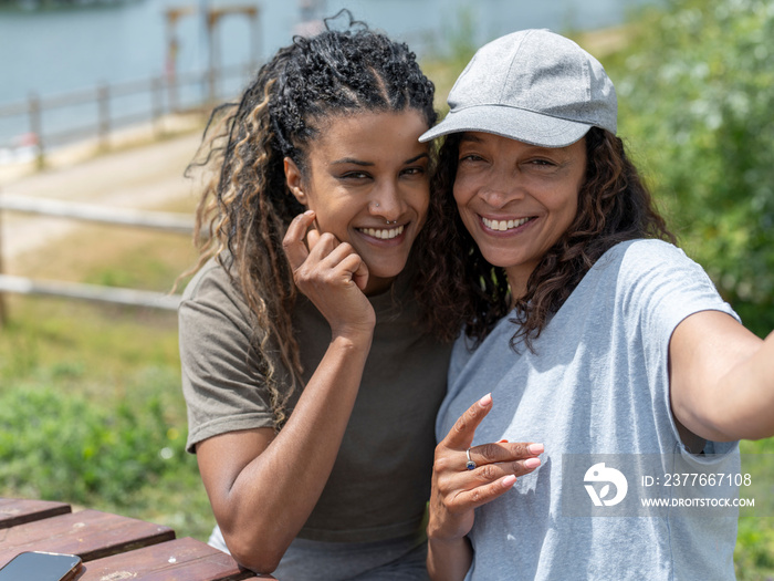 Portrait of smiling women sitting by picnic table